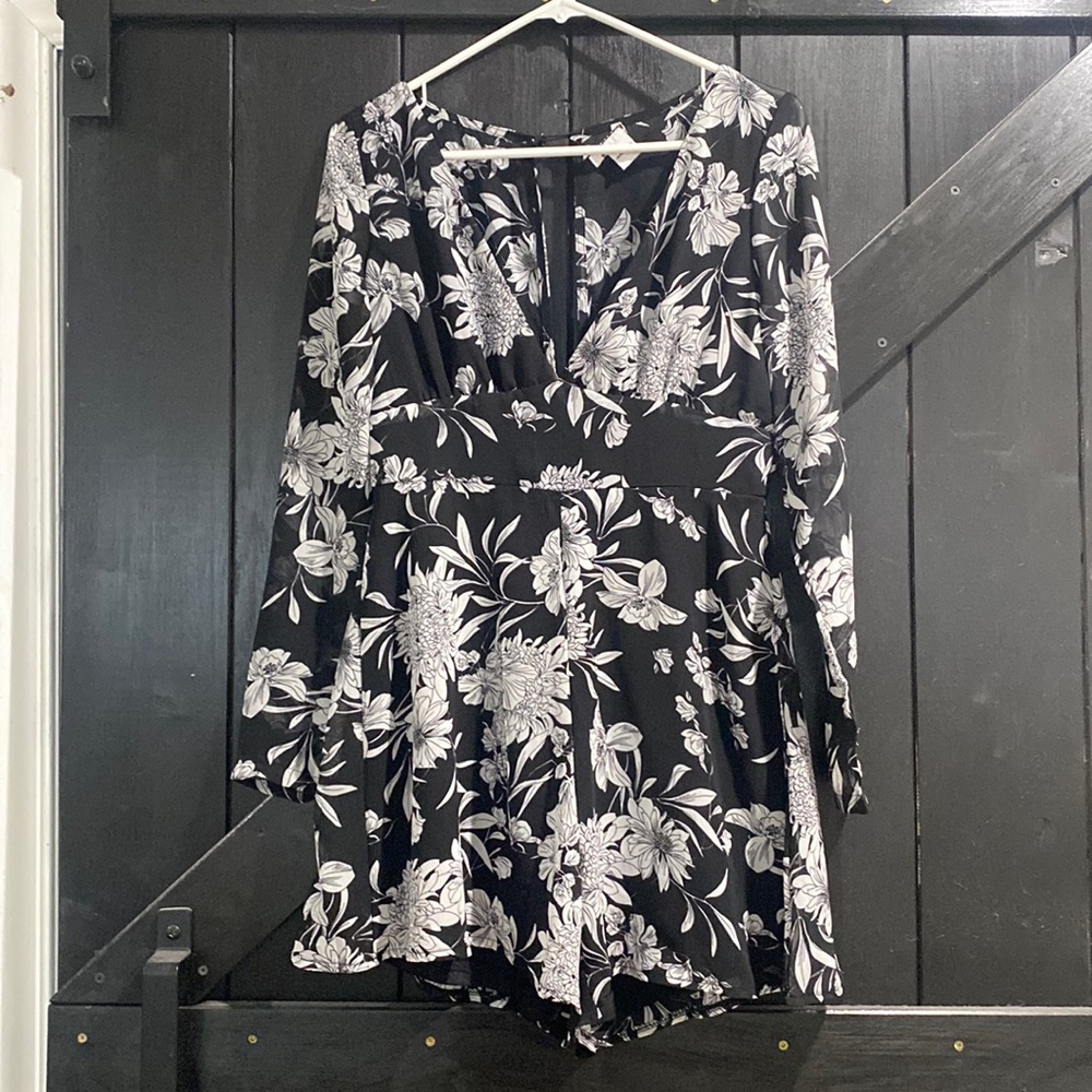 Black and white floral romper. V neck with long sleeves